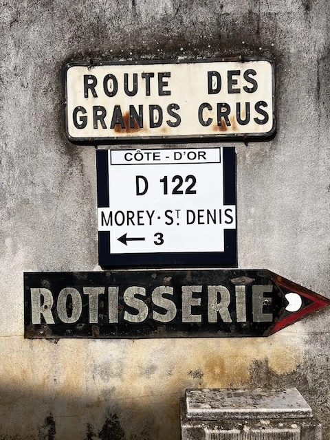 Wegwijzer langs de Route des Grands Crus in de Bourgogne, met bord naar Morey-Saint-Denis en verwijzing naar lokale rôtisserie – wijnroute Côte d'Or Frankrijk.